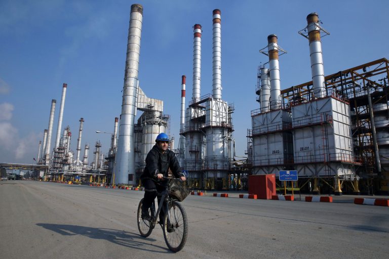In this Dec. 22, 2014 photo, an Iranian oil worker rides his bicycle at the Tehran oil refinery, south of the capital Tehran, Iran.Â (AP Photo/Vahid Salemi)