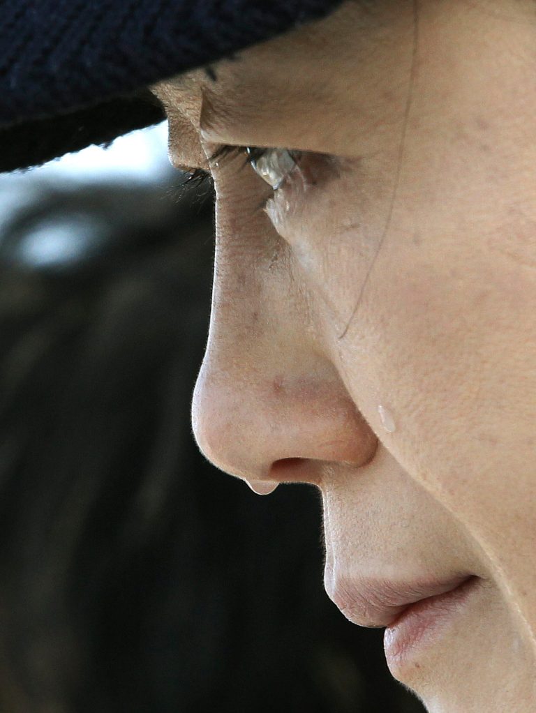 A relative of a passenger aboard the sunken ferry Sewol weeps as she waits for her missing loved one at a port in Jindo, South Korea, Monday, April 21, 2014. Divers continued the grim work of recovering bodies from inside the sunken South Korean ferry Monday, securing a new entryway into the wreck, as a newly released transcript showed the ship was crippled by confusion and indecision well after it began listing. The transcript suggests that the chaos may have added to a death toll that could eventually exceed 300. (AP Photo/Ahn Young-joon)