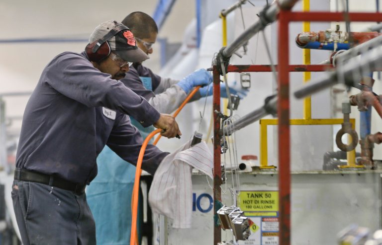 FILE - In this Thursday, Oct. 10, 2013, file photo, employees at Sheffield Platers Inc. work on the factory floor in San Diego.  The Institute for Supply Management issues its U.S. manufacturing index for November on Monday, Dec. 2, 2013. (AP Photo/Lenny Ignelzi, File)