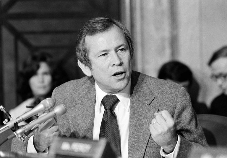 Senate Minority Leader Howard Baker of Tennessee gestures with a clinched fist as he speaks during a meeting of the Senate Foreign Relations Committee in Washington on Oct. 17, 1979. (AP Photo/Charles W. Harrity)