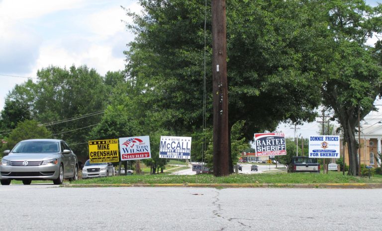   In this June 6, 2012 photo, signs for all four sheriff's candidates in Oconee County stand on display in a median in Walhalla, S.C. The race for sheriff has gotten nasty, with investigators saying one candidate tried to kidnap a man trying to kick him out of the race. (AP Photo/Jeffrey Collins)  