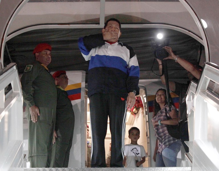   In this photo released by Miraflores Press Office, Venezuela's President Hugo Chavez, center, blows a goodbye kiss prior to boarding his plane at the Simon Bolivar International airport in Maiquetia near Caracas, Venezuela, Monday, Dec 10, 2012. For the first time, Chavez has designated a political heir, who said that if he suffers complications, Vice President Nicolas Maduro should be elected as Venezuela's leader to continue his socialist movement. (AP Photo/Miraflores Press Office, Marcelo Garcia)  
