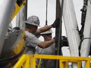 Crew members with Anadarko Petroleum Corp. work on a drilling platform in 2009 on a Weld County farm near Mead, Colo. Anadarko agreed to pay a record settlement of more than $5 billion to resolve environmental claims against subsidiary Kerr-McGee Corp. (AP Photo)