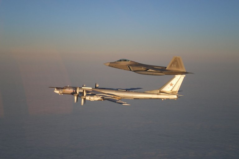 An F-22 escorts a Russian Tu-95 Bear bomber in this 2007 file photo. (AP photo)