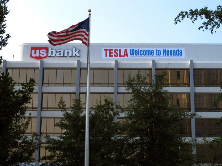 A banner welcoming Tesla to Nevada is hung on the US Bank building just south of the downtown Reno casino district on Tuesday, Sept. 9, 2014,  in Renvo, Nev. State lawmakers planned to meet in a special legislative session in Carson City on Wednesday to consider a package of tax breaks and incentives worth up to $1.3 billion to seal a deal to bring the electric car maker's $5 billion lithium battery 