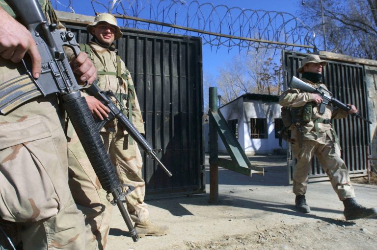 US Marine Robert Dewiit from Maryland (C) stands guard at post three inside the US embassy December 21, 2001 in Kabul, Afghanistan. (Photo by Paula Bronstein/Getty Images)