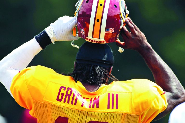 photos by Alex Brandon/AP
Washington Redskins rookie quarterback Robert Griffin III has struggled with certain aspects during training camp, including occasionally holding on to the ball too long.