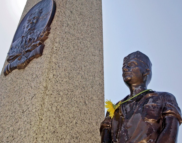 FILE - In this Sept. 1, 2005 file photo, a single flower adorns the neck of one of the bronze miners on the monument at the grave of Mary 