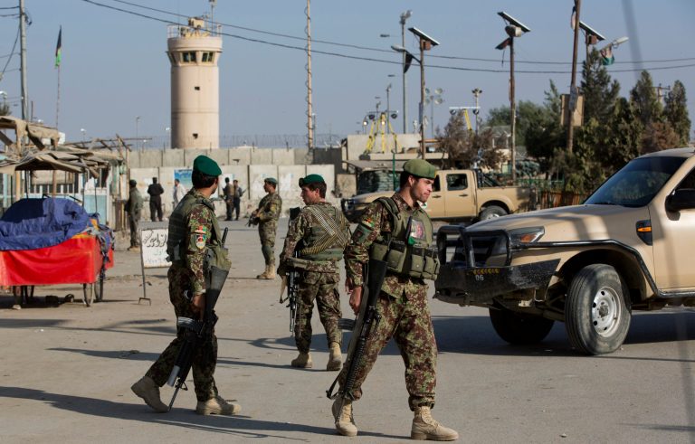 Afghan soldiers guard the road to the Bagram Airfield's main gate north of Kabul, Saturday, Nov. 12, 2016. (AP Photos/Massoud Hossaini)