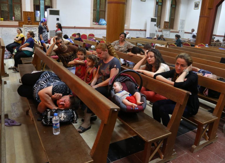 Displaced Iraqi Christians settle at St. Joseph Church in Irbil, northern Iraq, Thursday, Aug. 7, 2014. Late Wednesday, militants overran a cluster of predominantly Christian villages alongside the country's semi-autonomous Kurdish region, sending tens of thousands of civilians and Kurdish fighters fleeing from the area, several priests in northern Iraq said Thursday. (AP Photo/Khalid Mohammed)