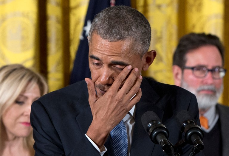 President Barack Obama wipes away tears from his eyes as he recalled the 20 first-graders killed in 2012 at Sandy Hook Elementary School, while speaking in the East Room of the White House in Washington, Tuesday, Jan. 5, 2016, about steps his administration is taking to reduce gun violence. Also on stage are stakeholders, and individuals whose lives have been impacted by the gun violence. (AP Photo/Carolyn Kaster)
