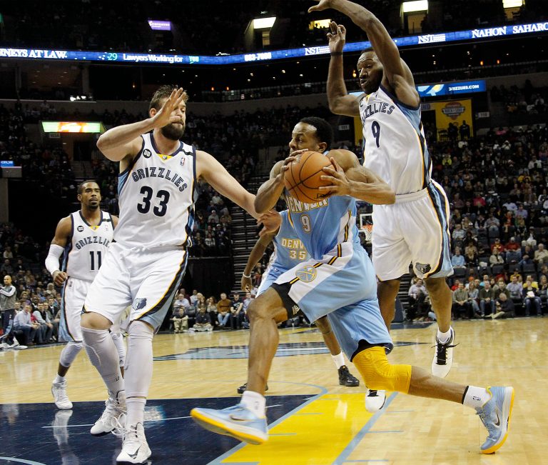   Denver Nuggets guard Andre Iguodala, center, drives to the basket against Memphis Grizzlies defenders Marc Gasol (33), of Spain, and Tony Allen, right, in the first half of an NBA basketball game on Saturday, Dec. 29, 2012, in Memphis, Tenn. (AP Photo/Lance Murphey)  