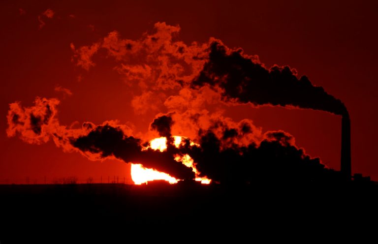 Steam from the Jeffrey Energy Center coal-fired power plant is silhouetted against the setting sun near St. Mary's, Kan. (AP/Charlie Riedel)
