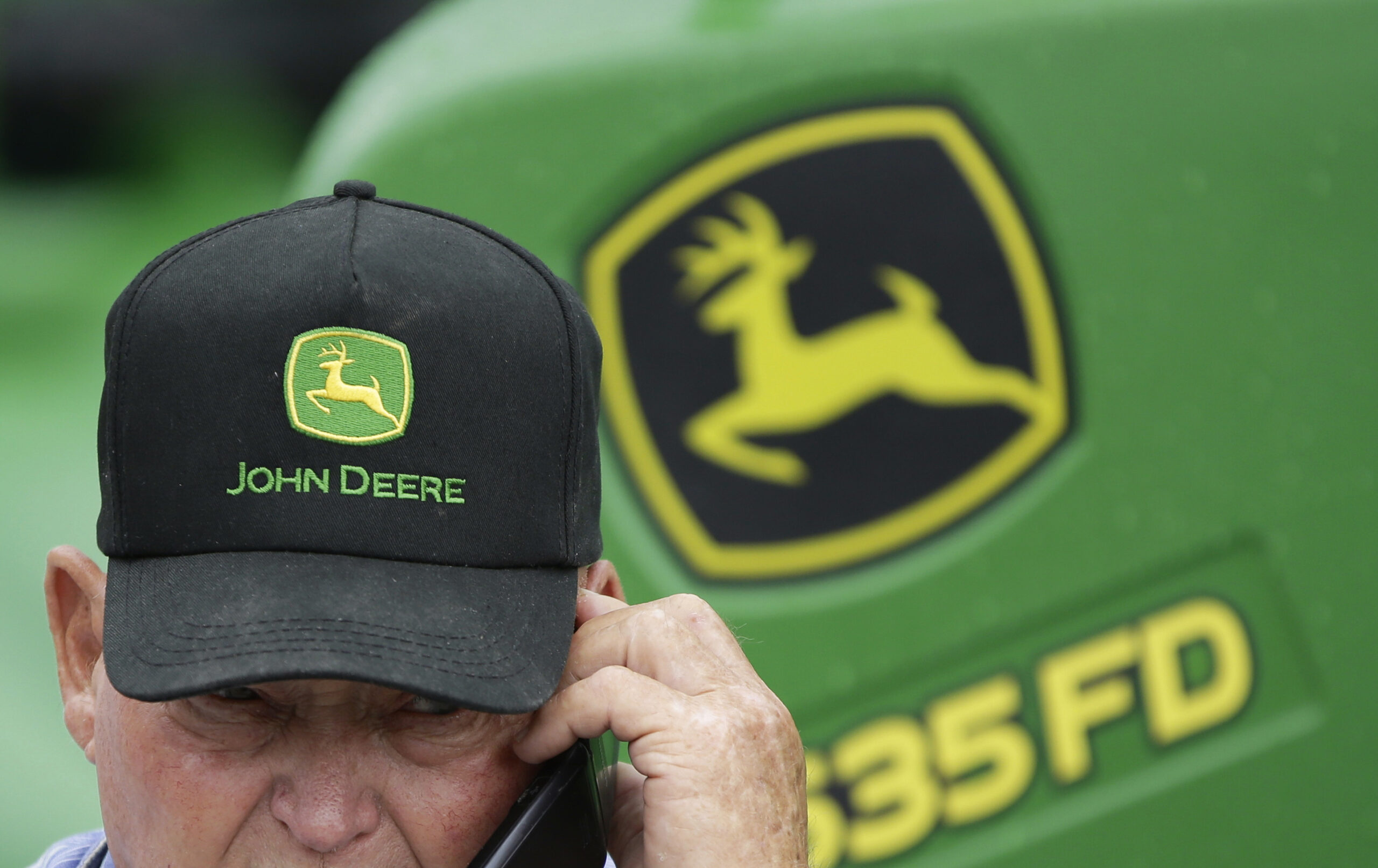 Deere 2Q profit falls, sales outlook cut