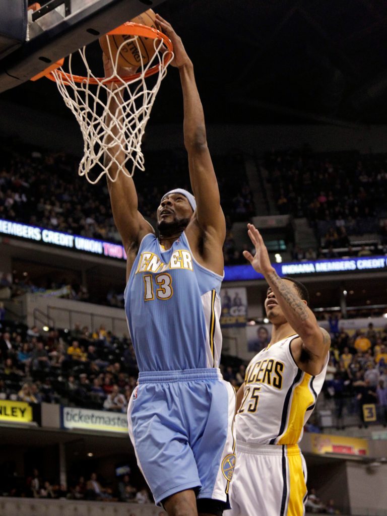   Denver Nuggets forward Corey Brewer, left, dunks in front of Indiana Pacers forward Gerald Green during the first half of an NBA basketball game in Indianapolis, Friday, Dec. 7, 2012. (AP Photo/AJ Mast)  