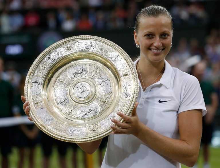 Petra Kvitova of Czech Republic holds the  trophy after winning the women's singles final against Eugenie Bouchard of Canada at the All England Lawn Tennis Championships in Wimbledon, London, Saturday, July 5, 2014. (AP Photo/Sang Tan)