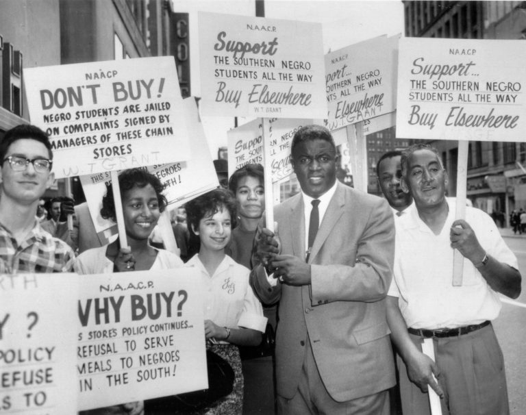 Former baseball star Jackie Robinson grabbed a sign and joined a picket line in Cleveland, Ohio, to protest discrimination against blacks at southern lunch counters, 1960. The picketing was organized by the N.A.A.C.P. (AP Photo)
