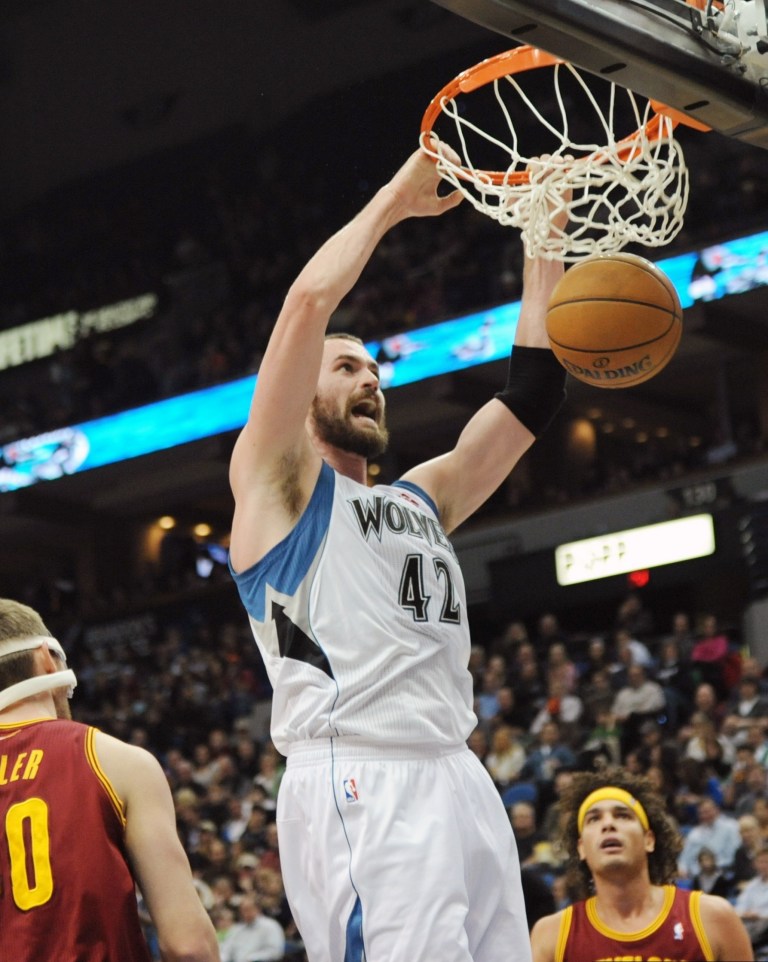   Cleveland Cavaliers' Anderson Varejao, right, of Brazil, and Tyler Zeller, left, watch as Minnesota Timberwolves' Kevin Love dunks in the first half of an NBA basketball game, Friday, Dec. 7, 2012 in Minneapolis. (AP Photo/Jim Mone)  