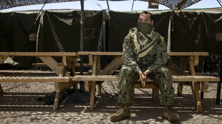 U.S. Navy Petty Officer 2nd Class Jonathan Bellomy, a preventive medicine technician, poses for a portrait with an improvised face mask at Erbil Air Base in the Kurdistan Region of Iraq, April 28, 2020. 
