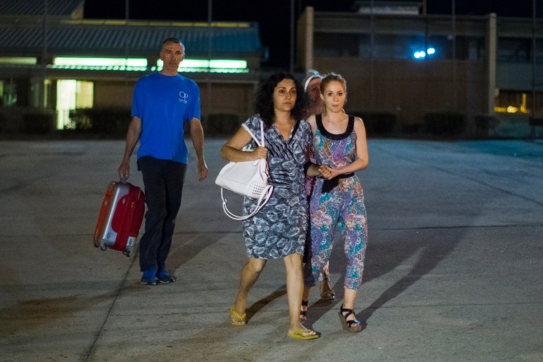 Brett and Naghemeh King, centre and left, leave Soto Del Real prison in Madrid, Spain, Tuesday, Sept. 2, 2014. British prosecutors are dropping the case against a couple who ended up in a Spanish jail after they tried to get treatment abroad for their son's severe brain tumor, authorities said Tuesday. Brett and Naghemeh King were pursued by police after they took 5-year-old Ashya out of a hospital in southern England against doctors' advice and traveled to Spain, where they planned to sell a property to pay for proton beam radiation therapy in the Czech Republic or the U.S. They were arrested on a British warrant on suspicion of cruelty to a person under 16 years of age, and are in custody in a jail near Madrid. (AP Photo/Andres Kudacki)