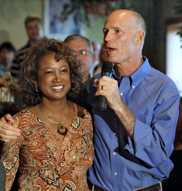 FILE- In this Oct. 26, 2010 file photo, Florida Republican gubernatorial candidate Rick Scott, right, puts his arm around running mate Rep. Jennifer Carroll, R-Jacksonville, during a campaign stop in New Port Richey, Fla. Carroll abruptly resigned Wednesday, March 13, 2012 after authorities questioned her ties into internet cafes that authorities say are fronts for gambling. (AP Photo/Chris O'Meara, File)