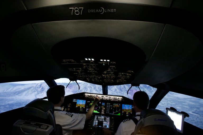 In this photo made Friday, May 9, 2014, American Airlines pilots Bill Elder, left, and Jim Dees work inside a Boeing 787 flight simulator in Fort Worth, Texas. In the next few months, dozens of American Airlines pilots will sit in the same simulator and learn the nuances of the controls before they can fly the real plane, which the airline will begin using for passenger flights early next year. (AP Photo/LM Otero)