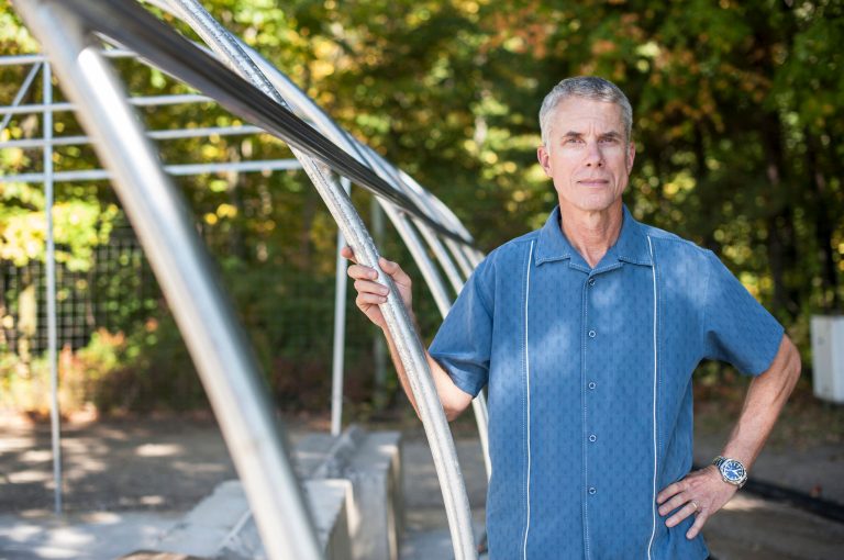 In this Oct. 2, 2013 photo provided by Michigan State University, Matt Raven, professor of community sustainability, leans on a hoophouse frame in East Lansing, Mich. Raven will establish a so-called incubator farm in Michigan's Upper Peninsula as part of an effort to improve food options in the region. Michigan State says parts of the Upper Peninsula lack convenient access to fresh, healthy and affordable food. The area faces high costs of importing supplies and food, lower-quality soils in places and a cool northern climate with a short growing season. The farm will be based at its Upper Peninsula Research and Extension Center in Chatham, a more than 1,200-acre research site.(AP Photo/Michigan State University, Kurt Stepnitz)