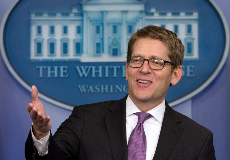 A clean-shaven White House press secretary Jay Carney jokes with reporters as he arrives for his daily news briefing at the White House in Washington, Friday, Jan. 24, 2014. During the briefing Carney discussed President Barack Obama's State of the Union Address, Iran, and other topics. (AP Photo/Carolyn Kaster)