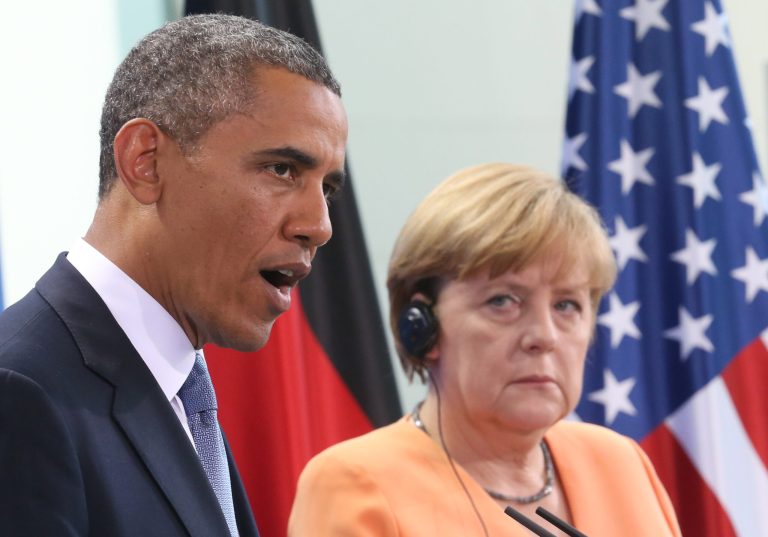 President Obama speaks during a press conference with German Chancellor Angela Merkel, right, at the Chancellery in Berlin. (AP/dpa, Michael Kappeler)