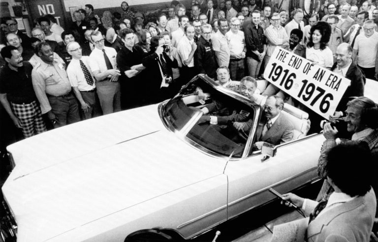 The last American-made convertible, a Cadillac Eldorado, rolls off the assembly line at General Motors' Cadillac plant in Detroit, April 21, 1976. It ends an era that began in 1916 with the automaker. Riding the car off the line, from left, H.B. Brawner, general manufacturing manager Cadillac; Detroit Mayor Coleman Young with Ed Kennard, Cadillac's general manager, driving. In back are representative employees of final assembly, engine and paint divisions. (AP Photo/Preston Stroup)