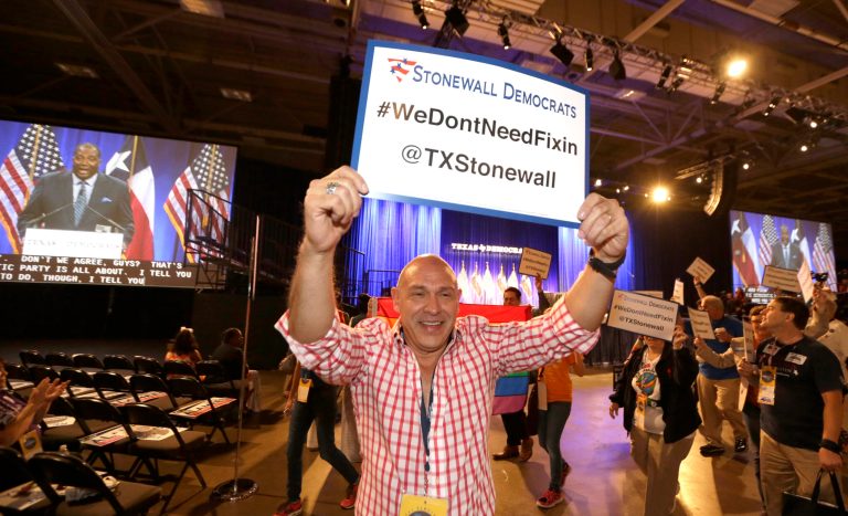 Eli Olivarez, president of the Texas Stonewall Democratic Caucus, leads the group as they march across the floor of Dallas Convention Center during the Texas Democratic Convention in Dallas, Saturday, June 28, 2014. Members of the Stonewall Democrats stormed the floor during a speech by state Sen. Royce West, whose district is hosting the gathering as West called from the stage, 