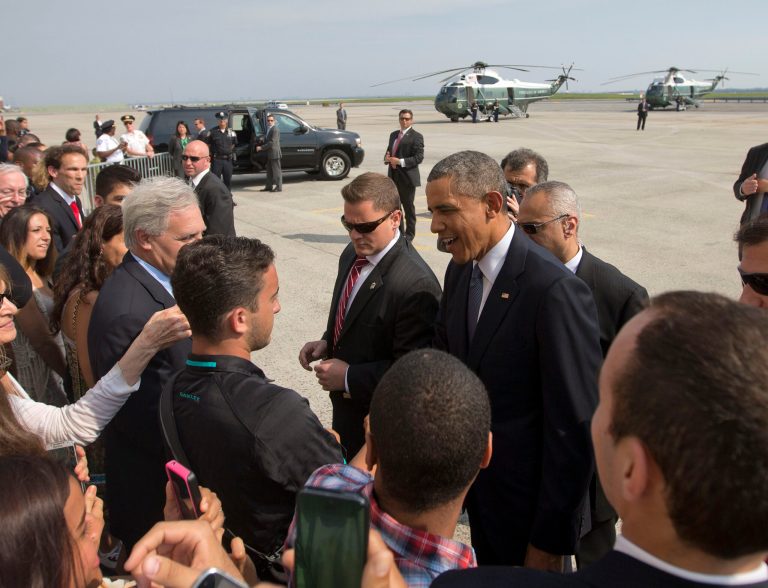 President Barack Obama greets guests on the tarmac upon his arrival on Air Force One at JFK International Airport in New York, Tuesday, June 17, 2014. Obama traveled to New York to speak at Democratic National Committee's (DNC) annual Lesbian, Gay, Bisexual and Transgender (LGBT) gala. (AP Photo/Pablo Martinez Monsivais)