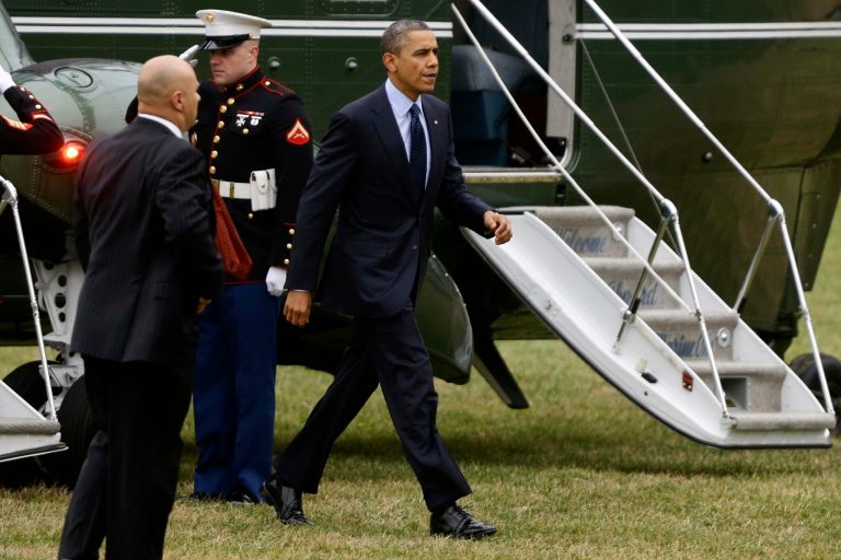   President Barack Obama steps off Marine One helicopter as he arrives at Walter Reed National Military Medical Center for a private visit with wounded military personnel and their families in Bethesda, Md., Thursday, Dec. 20, 2012. (AP Photo/Charles Dharapak)  