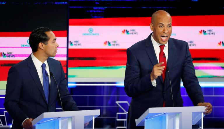Democratic presidential candidate Sen. Cory Booker, D-N.J., speaks during a Democratic primary debate hosted by NBC News at the Adrienne Arsht Center for the Performing Art, Wednesday, June 26, 2019, in Miami, as former Housing and Urban Development Secretary Julian Castro listens.