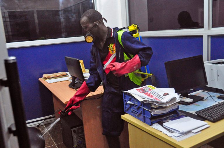 An employee  of the Monrovia City Corporation sprays disinfectant inside a government building in a bid to prevent the spread of  the deadly Ebola virus, in the city of Monrovia, Liberia, Friday, Aug. 1, 2014. U.S. health officials warned Americans not to travel to the three West African countries hit by the worst recorded Ebola outbreak in history. The travel advisory issued Thursday applies to nonessential travel to Guinea, Liberia and Sierra Leone, where the deadly disease has killed more than 700 people this year. (AP Photo/Abbas Dulleh)