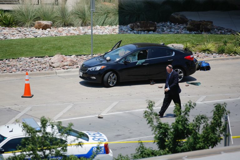 An investigator works the scene of an officer-involved shooting which prompted a lockdown at Dallas Love Field airport in Dallas Friday. (Tom Fox/The Dallas Morning News via AP)