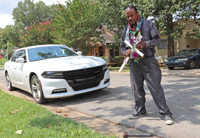 Earnest Franklin of Little Rock prepares to erect a cross in the front yard of Daniel Dewayne Lewis, on Tuesday, August 8, 2017, in Little Rock, Ark. Lewis was killed Sunday in a home-invasion robbery. His death was the 39th this year in Arkansas' capital city, putting it on a pace to approach a murder rate last seen during Little Rock's 1990s gang wars. (AP Photo/Kelly P. Kissel)