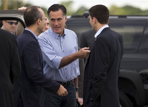 Republican presidential candidate, former Massachusetts Gov. Mitt Romney, center, talks with foreign policy adviser Dan Senor, left, and his vice presidential running mate, Rep. Paul Ryan, R-Wis., before boarding his campaign plane at Daytona International Airport, Saturday, Oct. 20, 2012, in Daytona Beach, Fla.  (AP Photo/ Evan Vucci)