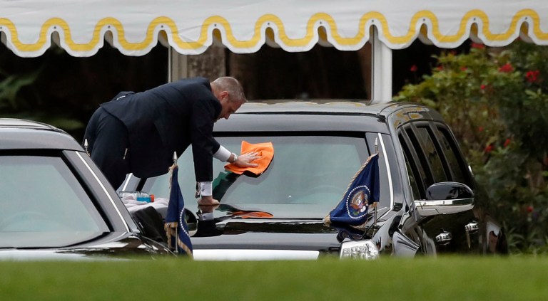 A Secret Service special agent cleans the windshield of the presidential limousine at Mar-a-Lago, Friday, March 3, 2017, in Palm Beach, Fla. (AP Photo/Alex Brandon)
