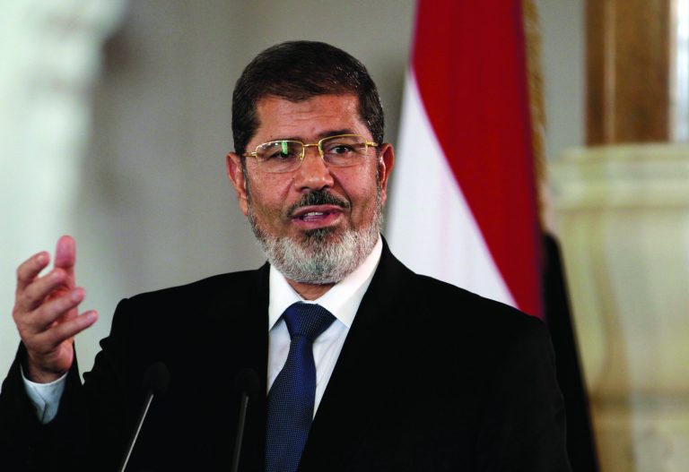 FILE - In this July 13, 2012 file photo, Egyptian President Mohammed Morsi speaks to reporters at the Presidential palace in Cairo. President Barack Obama begins his second term straining to maintain a good relationship with Egypt, an important U.S. ally whose president is a conservative Islamist walking a fine line between acting as a moderate peace broker and keeping his Muslim Brotherhood party happy with anti-American rhetoric. The White House last summer had hoped to smooth over some of the traditional tensions between Washington and the Brotherhood, a party rooted in opposition to Israel and the U.S., when Egypt overthrew dictator Hosni Mubarak and picked Morsi as its first democratically-elected leader. (AP Photo/Maya Alleruzzo, File)