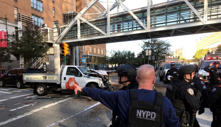 In this photo provided by the New York City Police Department, officers respond to a report of gunfire along West Street near the pedestrian bridge at Stuyvesant High School in lower Manhattan in New York, Tuesday, Oct. 31, 2017. (Martin Speechley/NYPD via AP)