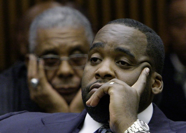   FILE - In this Oct. 28, 2008 file photo, former Detroit Mayor Kwame Kilpatrick, right, looks on as his father Bernard, left, watches at his sentencing hearing in Detroit. Businessman Karl Kado, who held contracts at Detroit's convention center, said Monday, Dec. 3, 2012 that he was a âhostageâ who felt compelled to pay thousands of dollars to then-Mayor Kwame Kilpatrick and his father or lose work. Kado told jurors that he personally delivered $5,000 to $10,000 to Kilpatrick âthree or four times.â He said he also delivered money through a top mayoral aide and separately paid $200,000 to $300,000 to Kilpatrick's father, Bernard. Kado is a crucial witness at the corruption trial, which began in September. (AP Photo/File)  
