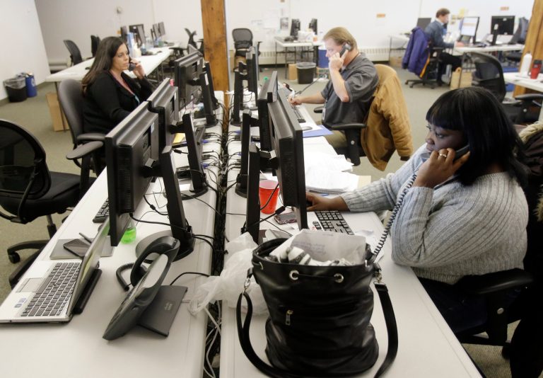 Guides work the phones Dec. 31 in St. Paul, Minn. for shoppers scrambling to finalize health coverage before the new year at Minnesota's insurance marketplace. The call center was the fallback for health insurance shoppers vexed by the troubled MNsure website. (AP Photo/Jim Mone)