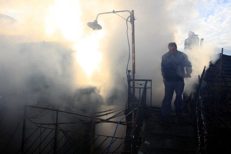   Firefighters try to extinguish the fire in a burning house where 3 boys lost their lives in a fire, burning in the village of Mesoropi in northern Greece, Saturday, Dec. 8, 2012. Giorgos Tsimirikas, his wife and his 6 youngest children were spending the weekend at his parents' house when the fire broke out early Saturday, caused by a wooden stove. The house had central heating but the owners used a stove because of the steep rise in the price of heating oil as a result of the Greek government's recent fiscal measures. (AP Photo/Haris Iordanidis)  