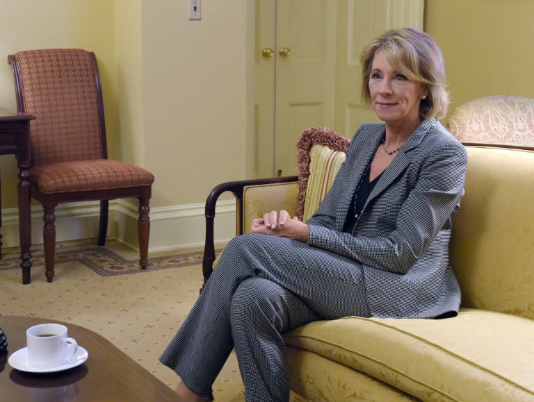 "Betsy DeVos is coming for your public schools," reads the Newsweek headline. (AP Photo/Susan Walsh)