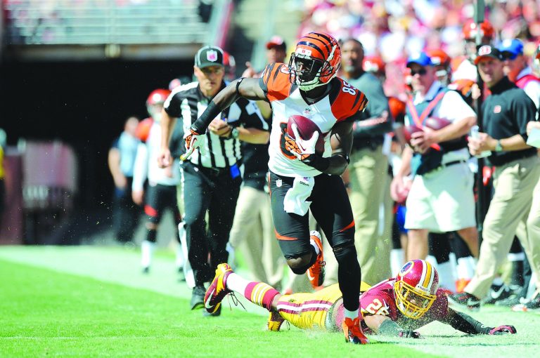 Patrick McDermott/Getty Images
Armon Binns got away from a stumbling Josh Wilson for a 48-yard touchdown reception in the first quarter Sunday.