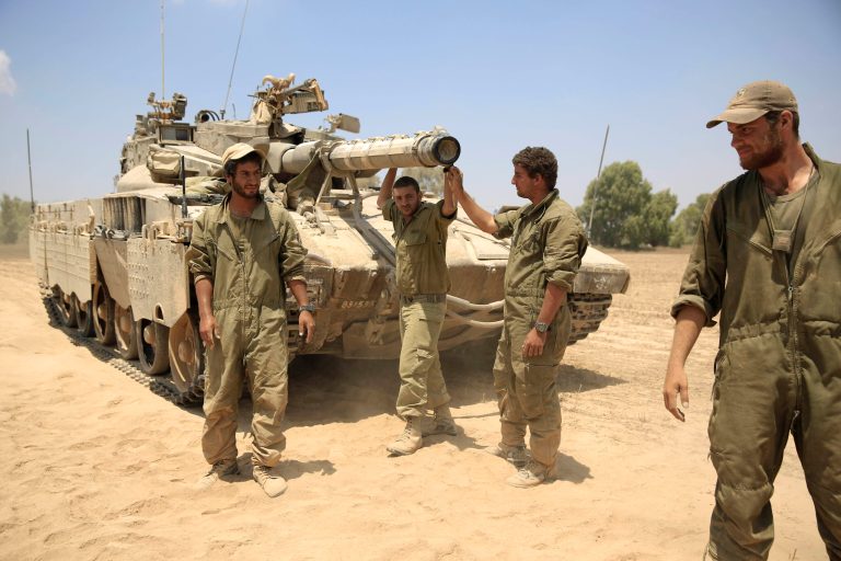 Israeli reserve solders gather in a staging area near the Israel-Gaza border, Tuesday, Aug. 5, 2014. (AP Photo/Tsafrir Abayov)