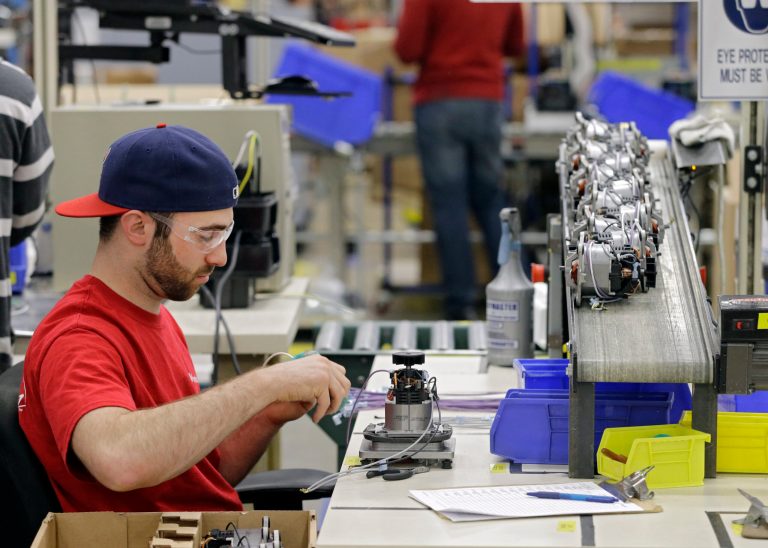 In this April 15, 2014 photo, Anthony Zingale wires blender motors at the Vitamix manufacturing facility in Strongsville, Ohio. A measure of the U.S. economy's health rose in March for the third consecutive month, a sign of stronger growth after harsh winter weather caused the economy's pace to slow. (AP Photo/Mark Duncan)