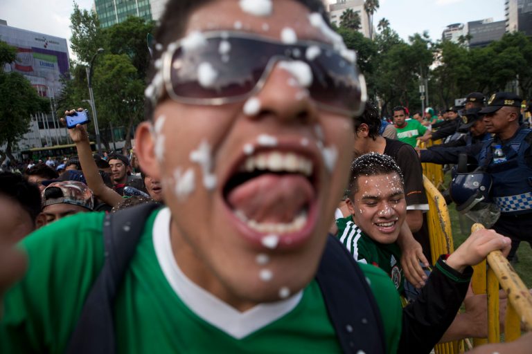Mexico soccer fans celebrate at the Independence Monument after their team tied with Brazil in their 2014 World Cup soccer match, in Mexico City, Tuesday, June 17, 2014. Mexico claimed a deserved point against Brazil in a largely frustrating Group A game which finished 0-0 at Estadio Castelao in Fortaleza. (AP Photo/Rebecca Blackwell)