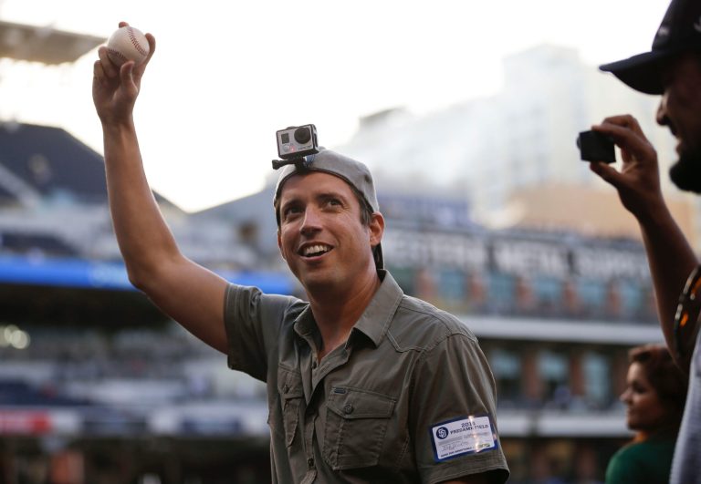 In this June 6, 2014 photo, GoPro founder and CEO Nick Woodman wears a GoPro camera on his head before throwing out a ceremonial first pitch before a baseball game between the San Diego Padres and the Washington Nationals, in San Diego. GoPro, the maker of wearable sports cameras, loved by mountain climbers, divers, surfers and other extreme sports fans, is expected to start selling its shares for the first time and begin trading on the Nasdaq stock market on Thursday, June 26, 2014. (AP Photo/Gregory Bull)